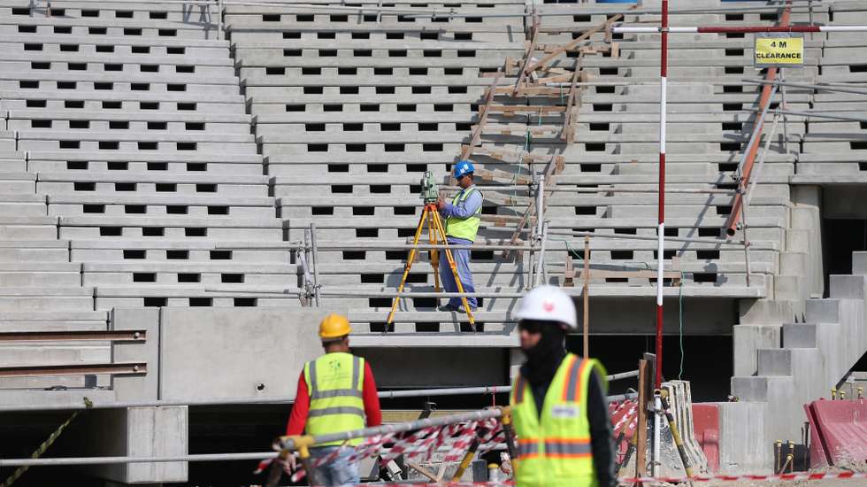 epa08083068 Construction workers at Lusail  Stadium during a media tour in Doha, Qatar, 20 December 2019. Lusail Stadium is one of the eight stadiums build for the FIFA World Cup 2022 in Qatar.  EPA/ALI HAIDER