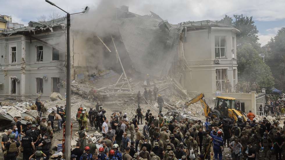epa11466653 Rescue workers at the site of a rocket strike on the 'Okhmadyt' children's hospital in Kyiv, Ukraine, 08 July 2024 amid the undoing Russian invasion. Russia massively attacked Ukraine with missiles 08 July, striking Kyiv, Dnipro, Kryvyi Rih, Sloviansk and Kramatorsk. More than 40 missiles of different types were launched, striking residential buildings, infrastructure and the children's hospital. At least seven people were killed and 25 injured as result of shelling in Kyiv according to the State Emergency Service report.  EPA/SERGEY DOLZHENKO