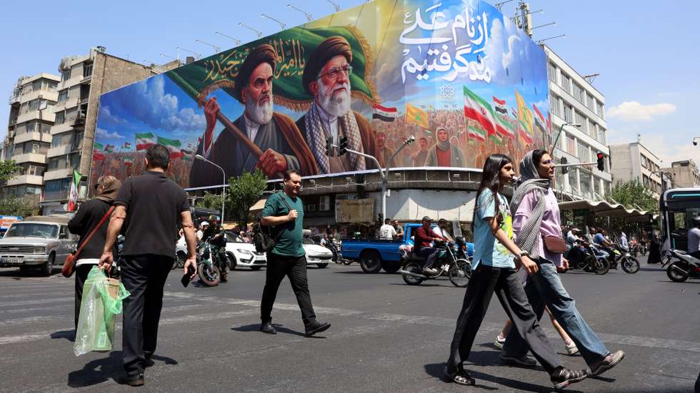 epa13027712 Iranians walk past a large billboard featuring late Iranian Supreme Leader Ayatollah Ruhollah Khomeini and Supreme Leader Ayatollah Ali Khamenei on a street in Tehran, Iran, 10 June 2026. According to US Central Command (CENTCOM), self-defense strikes were carried out against Iran near the Strait of Hormuz on 09 June in response to the downing of a US Army Apache helicopter.  EPA/ABEDIN TAHERKENAREH RESTRICTIONS: NO Access Israel Media/Persian Language TV Stations Outside Iran/Strictly No Access BBC Persian/VOA Persian/Manoto TV/Iran International TV. (As mandated by Iran's Directorate General for Foreign Media) --
