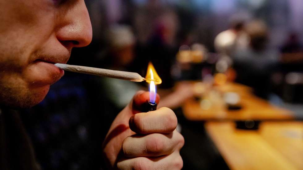 epa07523289 A man lights a weed joint in Cremers coffee shop, in The Hague, the Netherlands, 22 April 2019 (issued 23 April 2019). In the Netherlands, an experiment with state-regulated marijuana cultivation is starting. The aim of the experiment is to show whether weed can be removed from crime, but also what the use of cannabis means for health.  EPA/ROBIN VAN LONKHUIJSEN  ATTENTION: This Image is part of a PHOTO SET