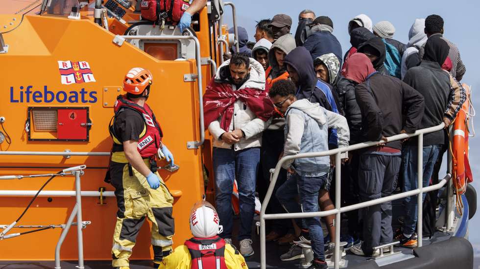 epa10811741 Migrants rescued from a boat crossing the English Channel land on Dungeness Beach in Kent, Britain, 21 August 2023. Despite the UK government's efforts to reduce the numbers of asylum seekers making the perilous journey across the English Channel on small boats, the improving weather conditions are allowing more migrants to attempt the crossing.  EPA/TOLGA AKMEN