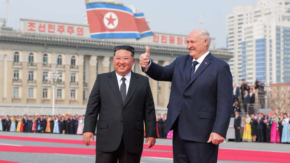 epaselect epa12850108 A photo released by the official North Korean Central News Agency (KCNA) shows Belarusian President Alexander Lukashenko (R) gesturing beside North Korean leader Kim Jong Un during a welcome ceremony at Kim Il Sung Square in Pyongyang, North Korea, 25 March 2026 (issued 26 March 2026). Lukashenko is on his first official visit to North Korea.  EPA/KCNA  EDITORIAL USE ONLY
