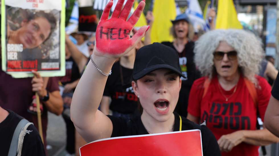 epaselect epa11470384 A demonstrator with her hand painted in red takes part in a protest march against Israeli Prime Minister Netanyahu's government and calling for the release of the hostages, outside the Kirya military headquarters in Tel Aviv, Israel, 10 July 2024. Some hostage families announced that they will begin a four-day march toward the Knesset in Jerusalem. According to the Israeli military, 116 Israelis, who were abducted and taken to the Gaza Strip during the 07 October 2023 attacks by Hamas, remain in captivity. Rallies in Israel have been critical of the government's handling of the crisis, demanding the immediate release of all hostages.  EPA/ABIR SULTAN