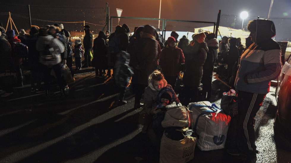 epa09771575 Local residents of the self-proclaimed Donetsk People's Republic wait to entrance Russia at the customs post 'Matveev Kurgan' in Rostov region, Russia, late 18 February 2022 (issued 19 February 2022). The head of the self-proclaimed Donetsk People's Republic Denis Pushilin announced a general mobilization. The OSCE Special Monitoring Mission has recorded a sharp increase in the intensity of shelling in the Donbass in recent days. Against the backdrop of rising tensions in the region, the authorities of the DPR and LPR announced the evacuation of women and children to the Rostov region of the Russia.  EPA/ARKADY BUDNITSKY