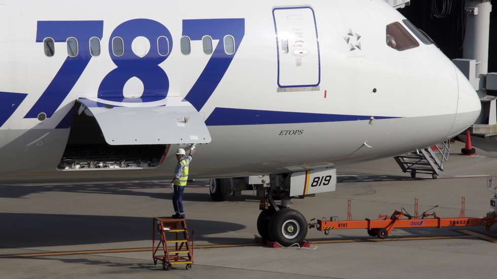 epa08967894 (FILE) - A member of ground staff of All Nippon Airways Co. closes a door near the battery room of a Boeing 787 Dreamliner before departure at Tokyo International Airport at Haneda, Tokyo, Japan, 30 October 2013 (reissued 26 January 2021). Boeing is due to release its 4th quarter 2020 results on 27 January 2021.  EPA/KIMIMASA MAYAMA *** Local Caption *** 56327701
