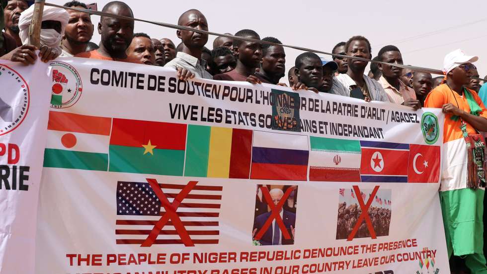 epa11291930 Demonstrators hold a banner during a protest rally to demand the withdrawal of US troops from Niger, in Agadez, Niger, 21 April 2024. In March 2024, the ruling military junta revoked a military agreement with the US. Niger's decision to oust the US military out of the country follows France's withdrawal of its forces from Niger last year.  EPA/ISSIFOU DJIBO
