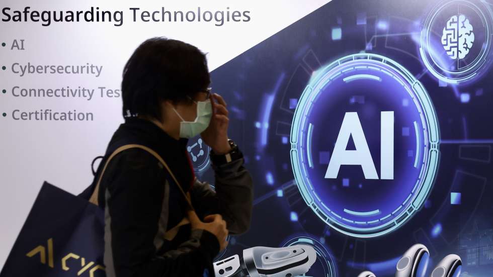 epa11338415 A person walks past an AI graphic illustration during the 'CYBERSEC 2024' cyber security expo in Taipei, Taiwan, 14 May 2024. The 10th edition of CYBERSEC 2024, which is held from 14-16 May under the theme 'Generative Future,' gathers leading cybersecurity professionals for more than 300 presentations and features exhibitions from over 500 global brands at Asia’s biggest CYBERSEC EXPO. This year introduces new segments such as the Cyber Taiwan Pavilion, Cyber Talent, and the AIoT and Hardware Security Zone.  EPA/RITCHIE B. TONGO
