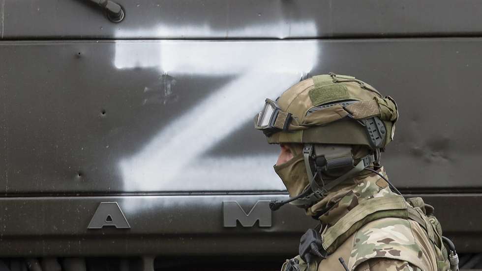 epa09853297 A Russian serviceman guards during food distribution organised by Russian army and militias of self-proclaimed LPR in village Trokhizbenka, Luhansk region, Ukraine, 27 March 2022. Chairman of the Government of the LPR Sergey Kozlov reported that as of March 22, the retreating Kyiv (Kiev) security forces had blown up 22 bridges, but the Republic would restore them. Russia will assist in the restoration and construction of infrastructure in the Republic. On 24 February Russian troops had entered Ukrainian territory in what the Russian president declared a 'special military operation', resulting in fighting and destruction in the country, a huge flow of refugees, and multiple sanctions against Russia. The letter Z has been used by Russian forces as an identifying sign on their vehicles in Ukraine.  EPA/SERGEI ILNITSKY