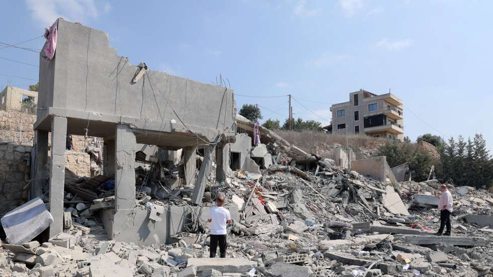 epa13170748 People inspect a damaged building after an Israeli airstrike on the village of Ansar, southern Lebanon, 15 August 2026. At least seven people were killed and two others injured in an Israeli airstrike on Ansar village early 15 August, according to the Lebanese official news agency (NNA).  EPA/WAEL HAMZEH