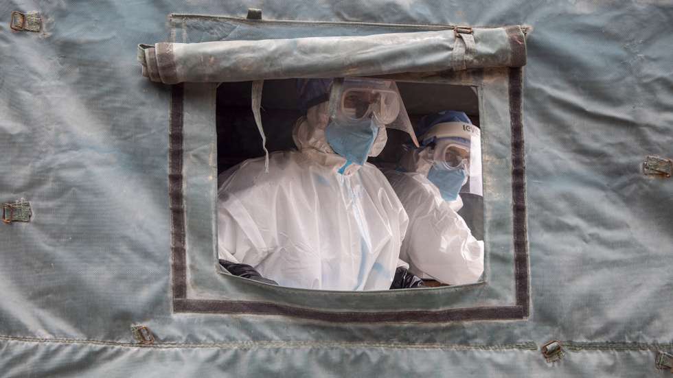 epa09173453 Nepalese army personnel wearing personal protective equipment (PPE) look on as they carry dead bodies of people who died with COVID-19 at Pashupati Electric Crematorium in Kathmandu, Nepal, 02 May 2021. As the number of COVID-19 cases continues to soar, the Ministry of Health and Population has issued a notice saying that it now has become 'next to impossible' for hospitals to provide beds for COVID-19 patients.  EPA/NARENDRA SHRESTHA