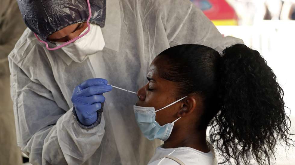 epa08609587 A woman wearing a protective face mask gives nose swab samples at a test station for Covid-19 coronavirus in Marseille, France, 17 August 2020. Marseille has been declared a zone of 'active circulation' for the Covid19 coronavirus, as cases surged in recent weeks.  EPA/GUILLAUME HORCAJUELO