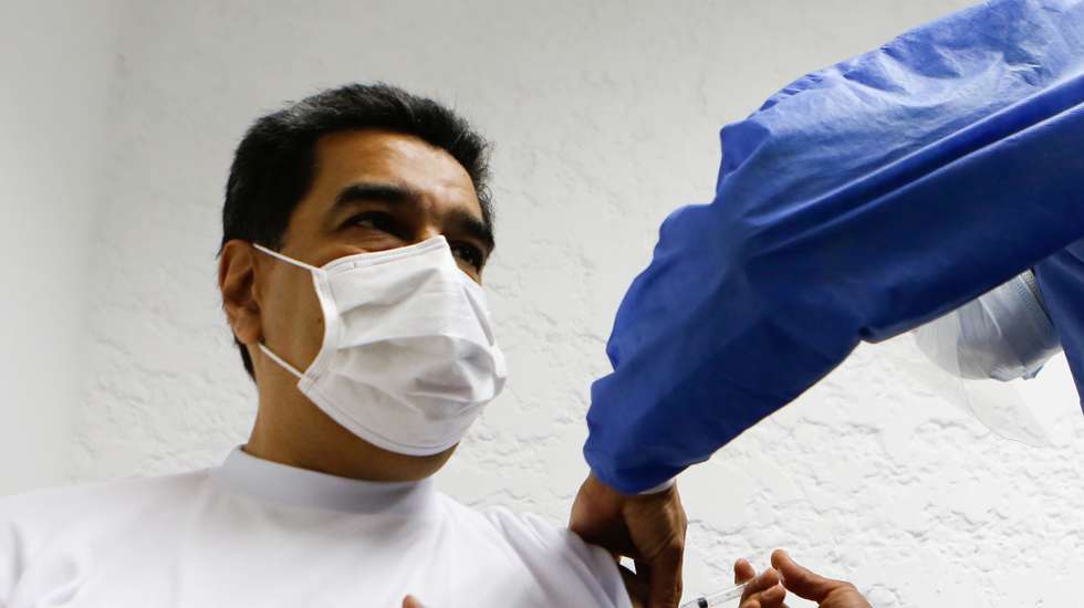 epa09057075 A handout photo made available by Miraflores press shows the President of Venezuela Nicolas Maduro (L) while he is vaccinated against the coronavirus in Caracas, Venezuela, 06 March 2021. Maduro and his wife Cilia Flores received the first dose of the Russian Sputnik V vaccine against Covid-19.  EPA/Miraflores Press HANDOUT EDITORIAL USE ONLY ONLY AVAILABLE TO ILLUSTRATE THE ACCOMPANYING NEWS (MANDATORY CREDIT) HANDOUT EDITORIAL USE ONLY/NO SALES