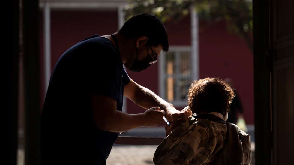 epa09153443 A person receives a dose of Chinese Sinovac vaccine against COVID-19, at a vaccination center in Santiago, Chile, 22 April 2021. Chile has spent weeks with an ICU occupancy rate above 95 percent due to a second wave of the pandemic that worsened in March 2021, and raised the number of infections to record highs.  EPA/Alberto Valdes