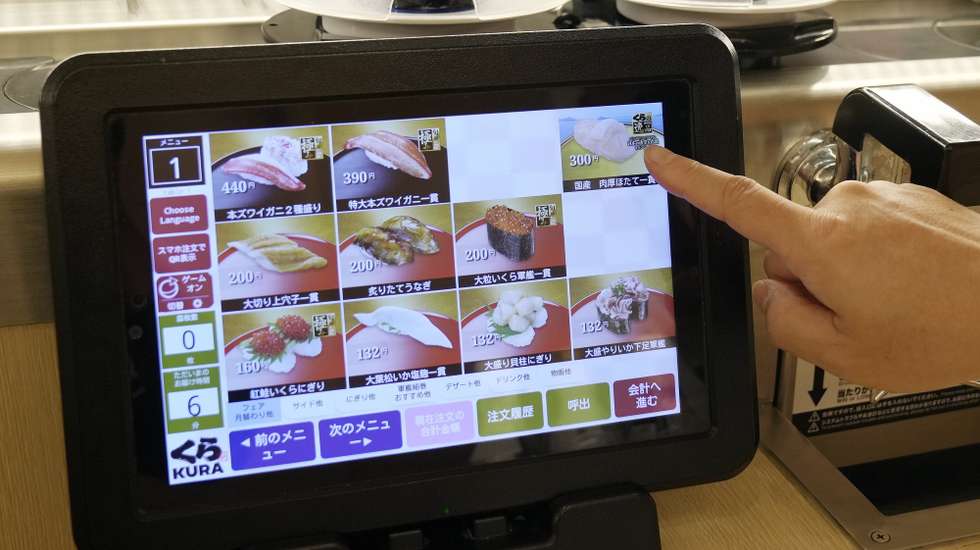 epa10897263 An Israeli tourist selects from the menu on the display to order sushi at Japanese sushi chain Kura Sushi global flagship restaurant at Asakusa in Tokyo, Japan, 03 October 2023. Kura Sushi started a campaign on 22 September 2023 to sell thick scallops sushi to support Japan's fishing industry. China imposed the ban on the import of Japanese seafood on 24 August 2023 just after Japan started releasing treated water from Tokyo Electric Power Company's tsunami-crippled Fukushima Daiichi nuclear power plant. If China continues the import ban for a long time, it will damage Japan's fishing industry heavily as China accounts for 22.5 per cent and Hong Kong accounts for 19.5 percent of Japan's total exports of seafood.  EPA/KIMIMASA MAYAMA