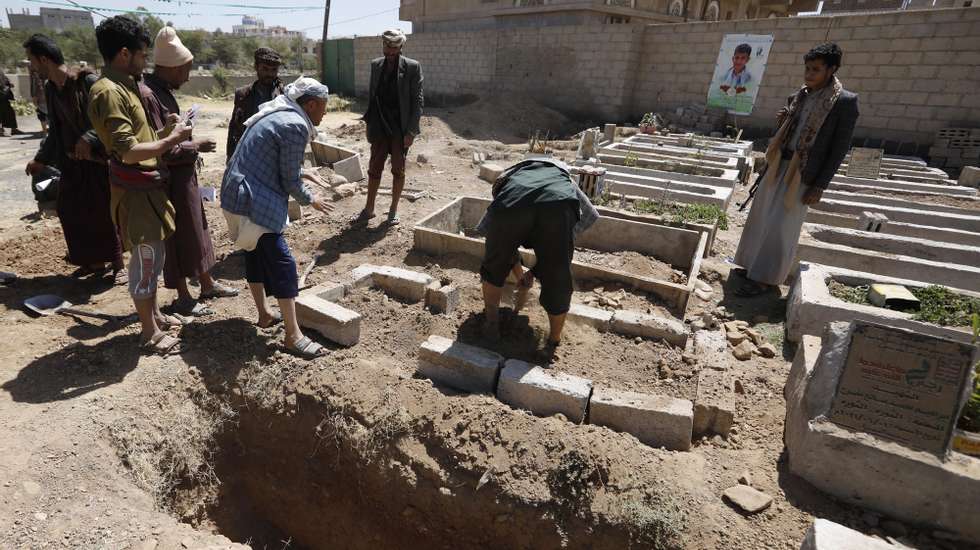 epa09527254 Yemenis bury the body of a slain Houthi fighter near a freshly dug grave during a funeral at a cemetery dedicated to slain Houthi fighters, in Sana&#039;a, Yemen, 16 October 2021. Saudi-led coalitionâ€™s airstrikes have allegedly targeted Houthi reinforcements heading to the front lines in the Yemeni province of Marib, killing more than 180 Houthi fighters in the past two days as the Houthis intensify their offensive in quest for control of the oil-rich province, the Yemeni government&#039;s last northern stronghold. The UN has estimated that at least 235 civilians were killed or injured during hostilities in Yemen in September 2021, the second highest monthly death toll in two years of ongoing conflict and the Saudi-led bombing campaign.  EPA/YAHYA ARHAB