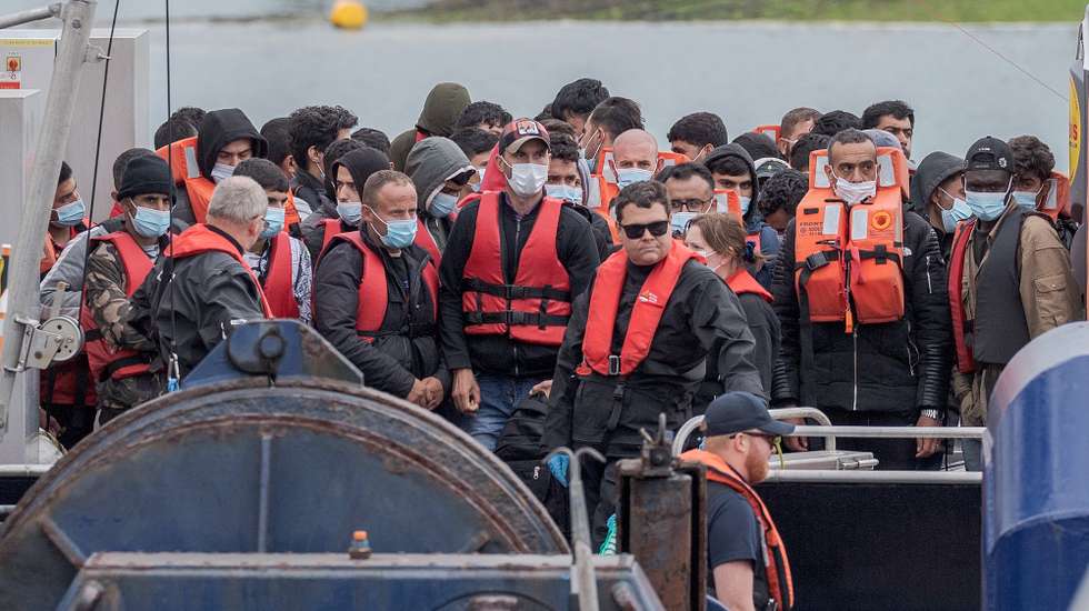 epa10041180 Migrants arrive on a boat after crossing the English Channel from France to Dover,  Britain, 29 June 2022. Under a scheme designed to crack down on migrants landing on British shores after crossing the Channel in small boats, the UK intends to provide those deemed to have arrived unlawfully with a one-way ticket to Rwanda. It is estimated that more than 12,000 people have crossed the Channel in 2022 compared to 5,654 in 2021 by this date.  EPA/STUART BROCK
