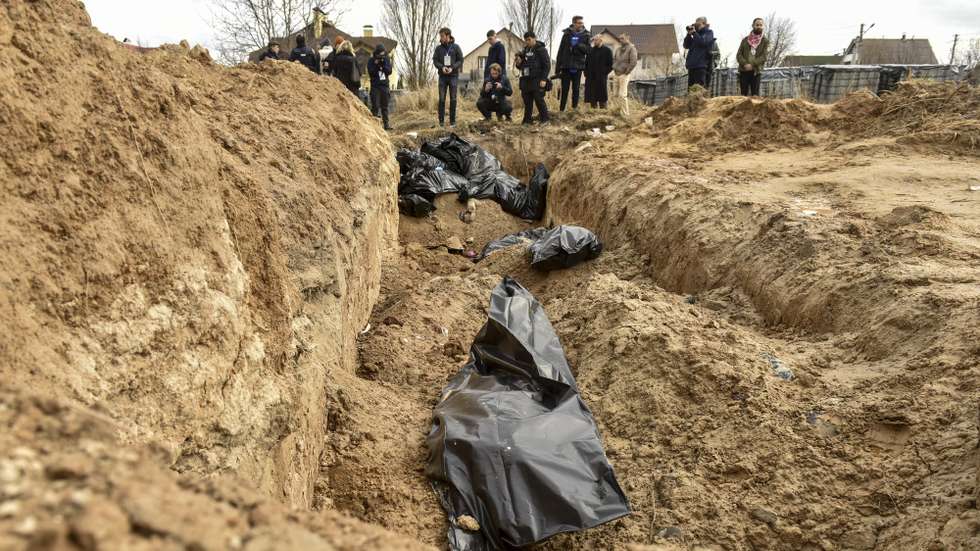 epa09870772 Bodies of civilians in plastic bags lay in a mass grave in Bucha city, which was the recaptured by the Ukrainian army, Kyiv (Kiev) area, Ukraine, 04 April 2022. More than 410 bodies of killed civilians were carried from the recaptured territory in Kyiv's area for exgumation and expert examination. The UN Human Rights Council has decided to launch an investigation into the violations committed after Russia's full-scale invasion of Ukraine as Ukrainian Parliament reported. On 24 February, Russian troops had entered Ukrainian territory in what the Russian president declared a 'special military operation', resulting in fighting and destruction in the country, a huge flow of refugees, and multiple sanctions against Russia.  EPA/OLEG PETRASYUK ATTENTION: GRAPHIC CONTENT