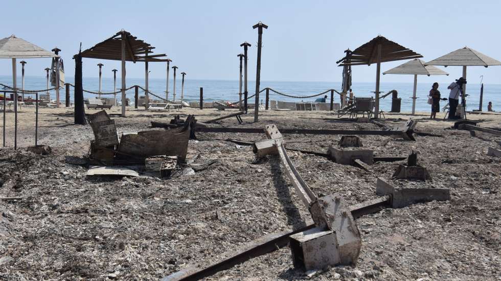 epa09382506 A view of a bathing establishment destroyed by a fire near Catania, Sicily Island, southern Italy, 31 July 2021. A largest number of forest fires are burning in Sicily. Fire brigade teams on the ground are currently engaged in Catania on various vegetation fires that are affecting the area.  EPA/ORIETTA SCARDINO