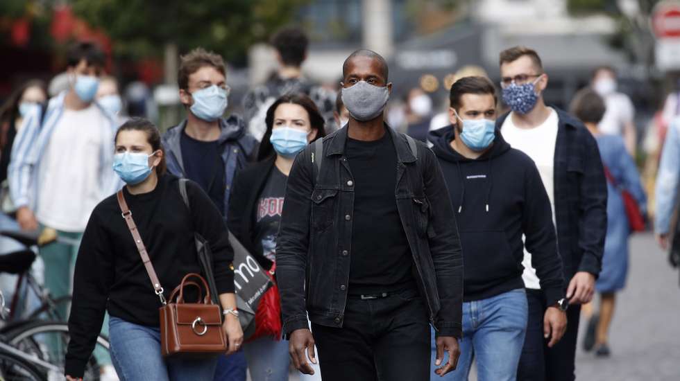 epa08632225 People wearing protective face masks walk in the streets in Paris, France, 28 August 2020. As of 8am on 28 August, protective face masks are mandatory across the city of Paris, a measure annouced by French Prime Minister Jean Castex on 27 August to fight the rising spread of coronavirus SARS-CoV-2 which causes the Covid-19 disease. Cases in France have surged in recent weeks, with over 6000 new cases recorded in a 24 hour period.  EPA/YOAN VALAT