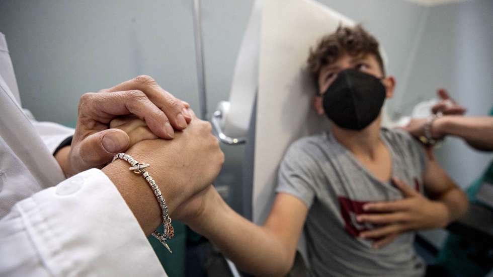 epa09250588 A boy receives a vaccine against Covid-19 on the first junior Open day dedicated to children between 12 and 16 years in Rieti, Lazio Region Italy, 06 June 2021. 120 Pfizer doses have been planned for the appointment. The Italian drugs agency AIFA approved on 31 May the usage of Pfizer-BioNtech vaccine for youngsters between 12 and 15 years old.  EPA/MASSIMO PERCOSSI