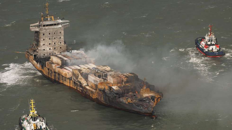 epa11956642 An aerial view as smoke billows from the MV Solong cargo ship in the North Sea, off the Yorkshire coast , Britain, 11 March 2025. Thirty-six people were reportedly brought ashore, and one taken to hospital, after the collision of the oil tanker Stena Immaculate and the Solong, a cargo vessel, off the East Yorkshire coast on 10 March 2025 morning. The coastguard has said a search has been called off for one missing crew member of the Solong.  EPA/DAN KITWOOD / POOL