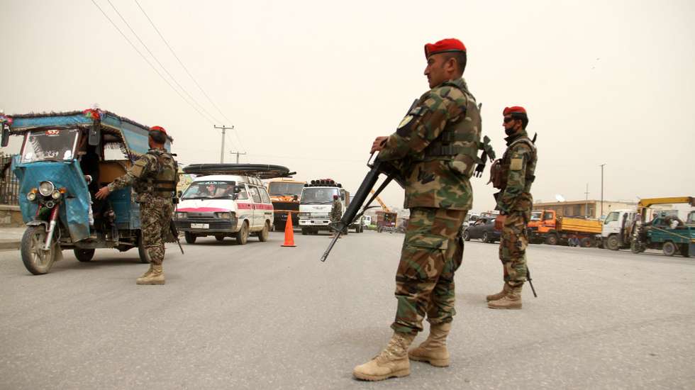 epa05921131 Afghan army soldiers stand guard on a roadside as security has been high intensified following a military base attack in Balkh province, in Ghazni, Afghanistan, 22 April 2017. According to latest media reports on 22 April 2017, at least 140 Afghan soldiers were killed when Taliban fighters attacked the army base in Mazar-i-Sharif on 21 April. The attack, perpetrated by as many as 10 fighters, occurred as the soldiers were leaving a mosque after Friday prayers and eating dinner at the base's canteen.  EPA/GHULAM MUSTAFA