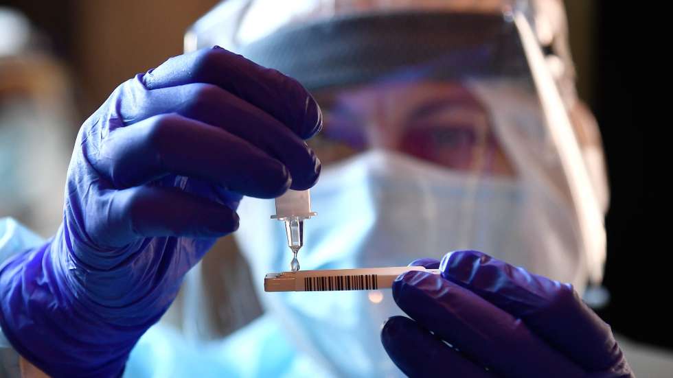 epa08818283 A health worker of Asl 3 (Local Health Company) collects a nose swab sample for a polymerase chain reaction (PCR) test at Siberia Door, one of the historic gates to enter the city of Genoa, in the middle of town, set up for free coronavirus testing facility during the coronavirus disease COVID-19 outbreak, in Genoa, Italy, 13 November 2020.  EPA/LUCA ZENNARO