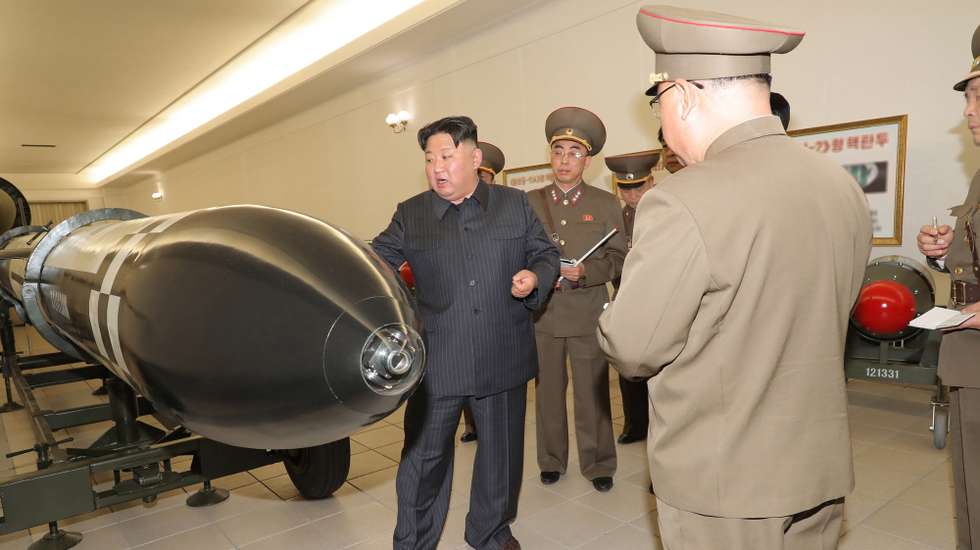 epa10546328 A photo released by the official North Korean Central News Agency (KCNA) shows North Korean leader Kim Jong Un speaking to officials during a visit to the Nuclear Weapons Institute in Pyongyang, North Korea, 27 March 2023 (issued 28 March 2023). According to KCNA, North Korean leader Kim Jong Un 'guided the work for mounting nuclear warheads on ballistic missiles' at the institute.  EPA/KCNA   EDITORIAL USE ONLY