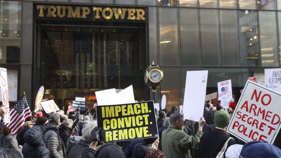 epa12643401 People hold placards in front of Trump Tower while marching during a 'No war, no kings, no ICE' protest in New York, New York, USA, 11 January 2026. Protesters rallied against the Trump administration's actions in Venezuela and the shooting of US citizen Renee Nicole Good by an ICE officer in her vehicle during an operation in South Minneapolis on 07 January 2026.  EPA/SARAH YENESEL