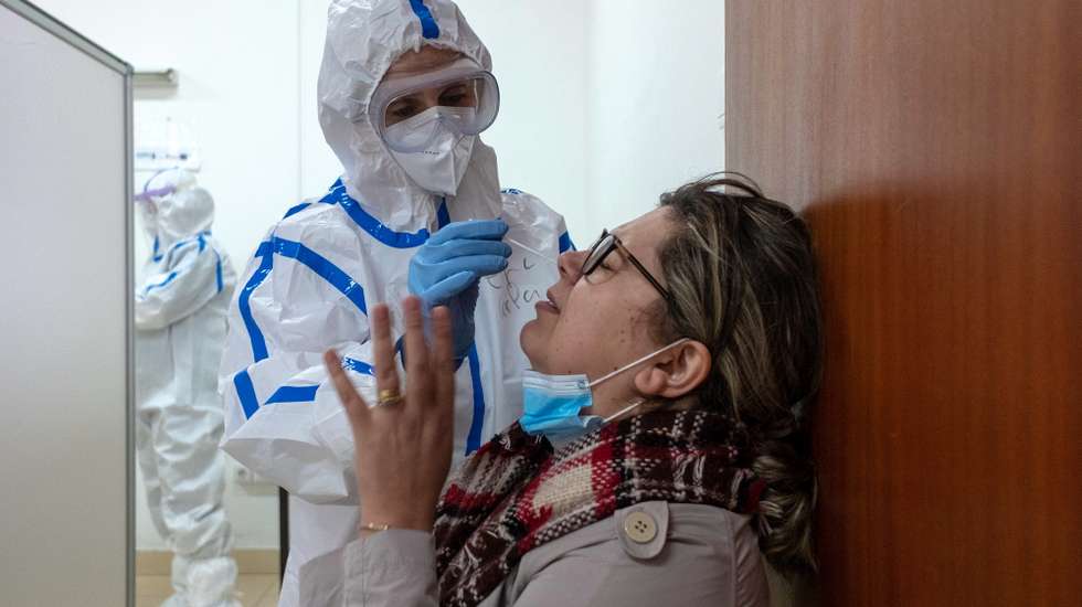 epa08949552 A health professional tests a woman for COVID-19 in the parish of Ponta Garca, Ponta Delgada, island of Sao Miguel, Azores, Portugal, 19 January 2021. The population is being tested with the COVID-19 rapid tests.  EPA/EDUARDO COSTA