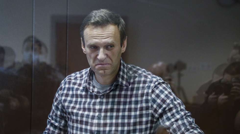 epa09025232 Russian opposition leader Alexei Navalny stands inside a glass cage prior to a hearing at the Babushkinsky District Court in Moscow, Russia, 20 February 2021. The Moscow City court will hold a visiting session at the Babushkinsky District Court Building to consider Navalny's lawyers appeal against a court verdict issued on 02 February 2021, to replace the suspended sentence issued to Navalny in the Yves Rocher embezzlement case with an actual term in a penal colony.  EPA/YURI KOCHETKOV MANDATORY CREDIT