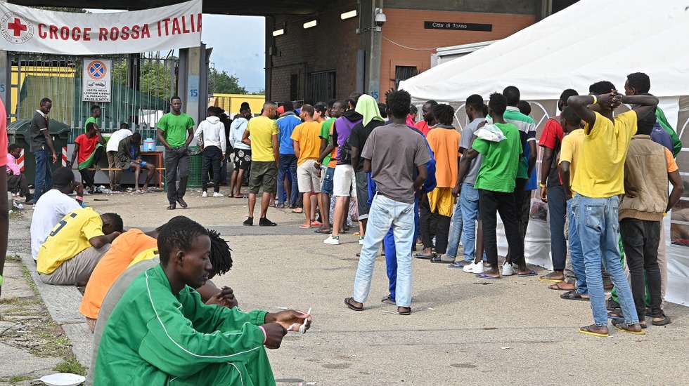 epa10871637 Migrants queue at the food distribution point at the Red Cross reception centre in Via Tres, Turin, Italy, 20 September 2023. The center houses some 500 people in a compound and facilities which are meant for between 140 and 180 people in need. Italy saw an influx of thousands of migrants in the past weeks. According to Italy's Interior Ministry, nearly 126,000 immigrants and refugees have entered the country as of 2023, more than twice as many as during the same time period in 2022.  EPA/ALESSANDRO DI MARCO