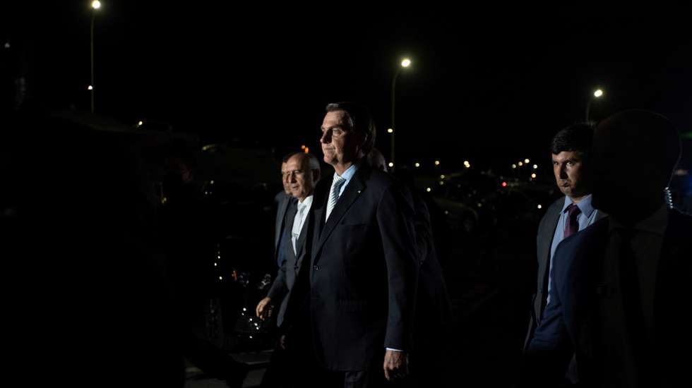 epa09034866 The President of Brazil Jair Bolsonaro (c) leaves the Planalto Palace towards the National Congress building, after the ceremony of approval of the Central Bank Autonomy Law, in Brasilia, Brazil, 24 February 2021. Brazilian President Jair Bolsonaro renewed his Government with changes in two ministries and sanctioned a law that gives autonomy to the Central Bank, which is part of his objective of liberalizing the country's economy.  EPA/Joedson Alves