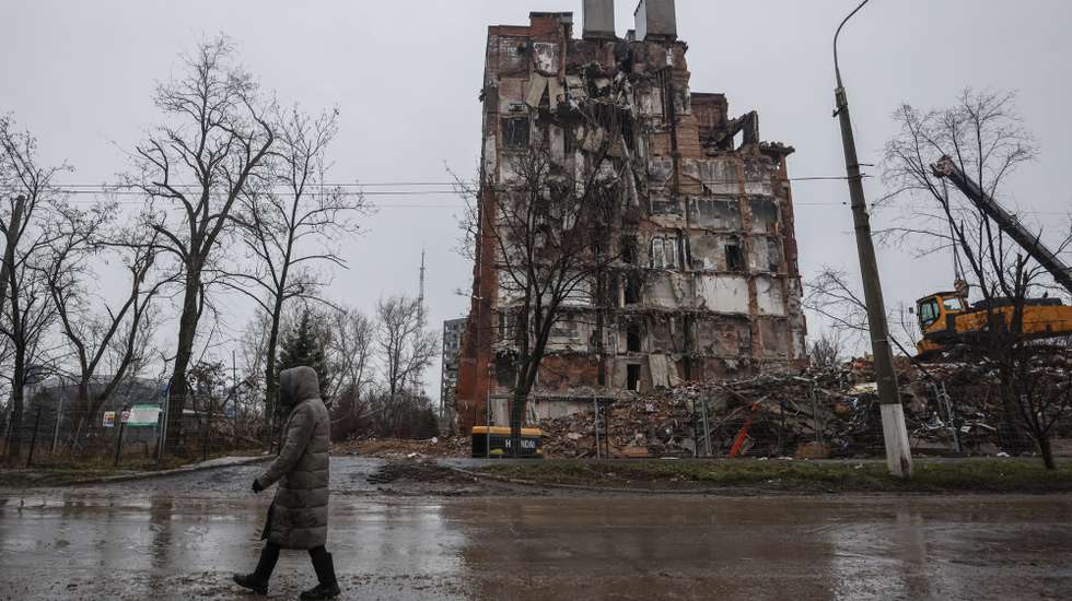 epa10362476 A local man walks in front of a destroyed building in downtown Mariupol, Ukraine, 12 December 2022. Mariupol had seen a long battle for its control between the Ukrainian forces and the Russian army and Russian backed separatist Donetsk Peopleâ€™s Republic (DPR) as well as a siege, the hostilities lasted from February to the end of May 2022 killing thousands of people and destroying most of the city in the process. According to the DPR government which took control after May 2022, more than five thousand builders are currently working in Mariupol, they expect the city to be completely rebuilt in three years' time.  EPA/SERGEI ILNITSKY
