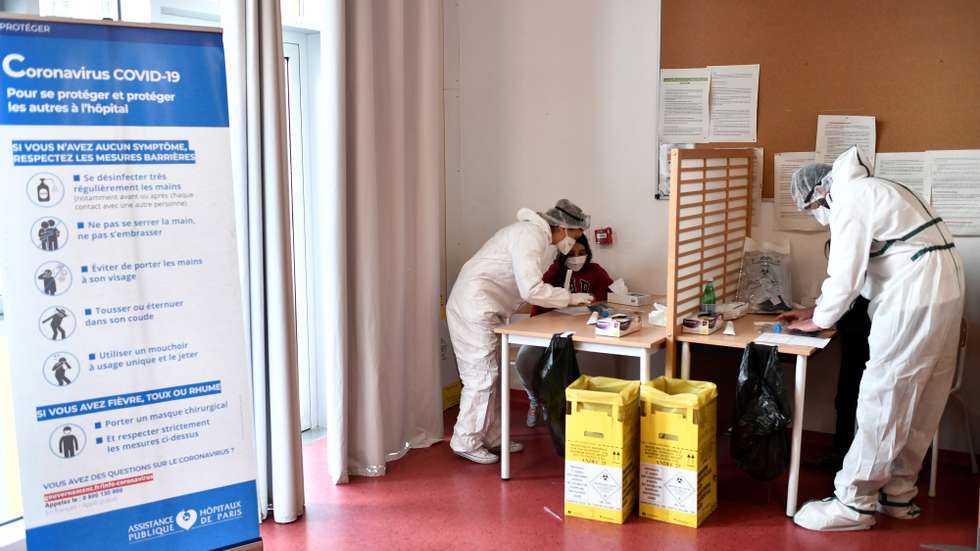 epa09004492 Health workers colect samples from pupils at the Louise Bourgeois school in Paris, during a visit by the French Prime minister and Health minister on the implementation of Covid-19 (novel coronavirus) tests using saliva samples in Paris, Fance, 11 February 2021. Saliva tests to screen for Covid-19 on symptomless people, but not rapid tests, were given the green light from France's High Authority of Health (HAS) on February 11, 2021, allowing repeated screenings in schools and universities. The tests, which are less unpleasant than nasal swabs, will be carried out in schools and universities at the return of the winter holidays.  EPA/STEPHANE DE SAKUTIN / POOL MAXPPP OUT