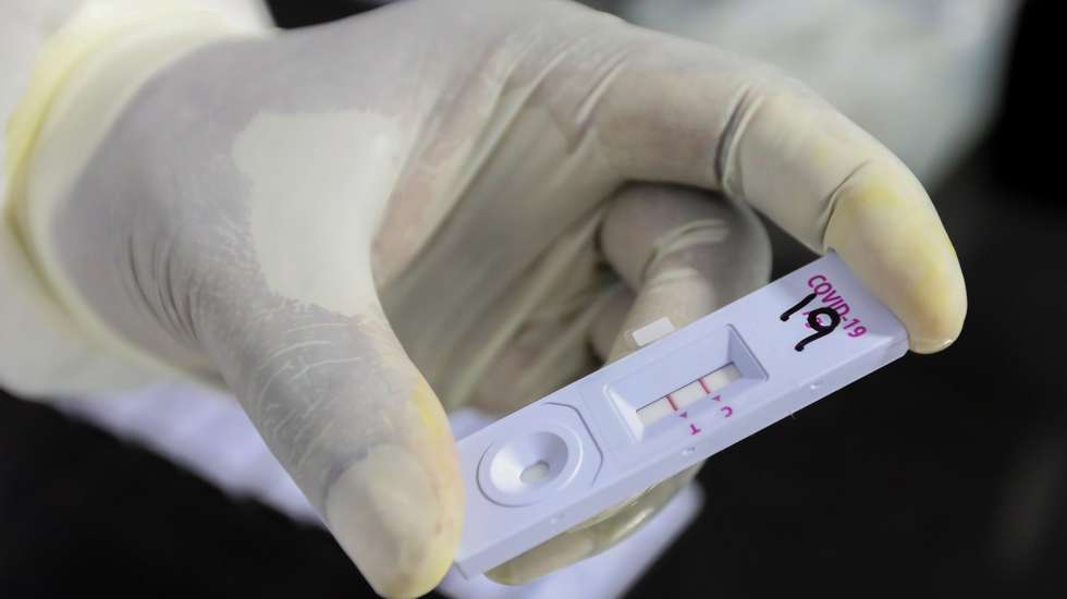 epa08869840 A Sri Lankan health officer performs a COVID-19 Rapid Antigen Test at a mobile laboratory just after collecting a swab from a lockdown area in Colombo, Sri Lanka, 08 December 2020. Sri Lanka is in the midst of the new wave of Covid-19 and the number of cases is increasing day after day.  EPA/CHAMILA KARUNARATHNE