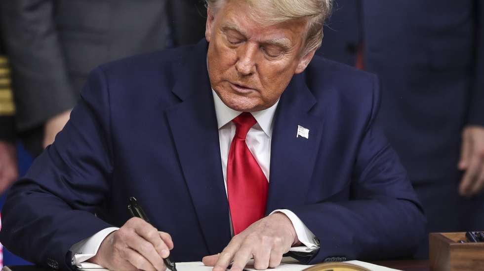 epa08871446 US President Donald J. Trump signs an executive order giving priority to Americans to receive American coronavirus vaccines during the Operation Warp Speed Vaccine Summit in the Eisenhower Executive Office Building at the White House in Washington, DC, USA,  on 08 December 2020.  EPA/Oliver Contreras / POOL