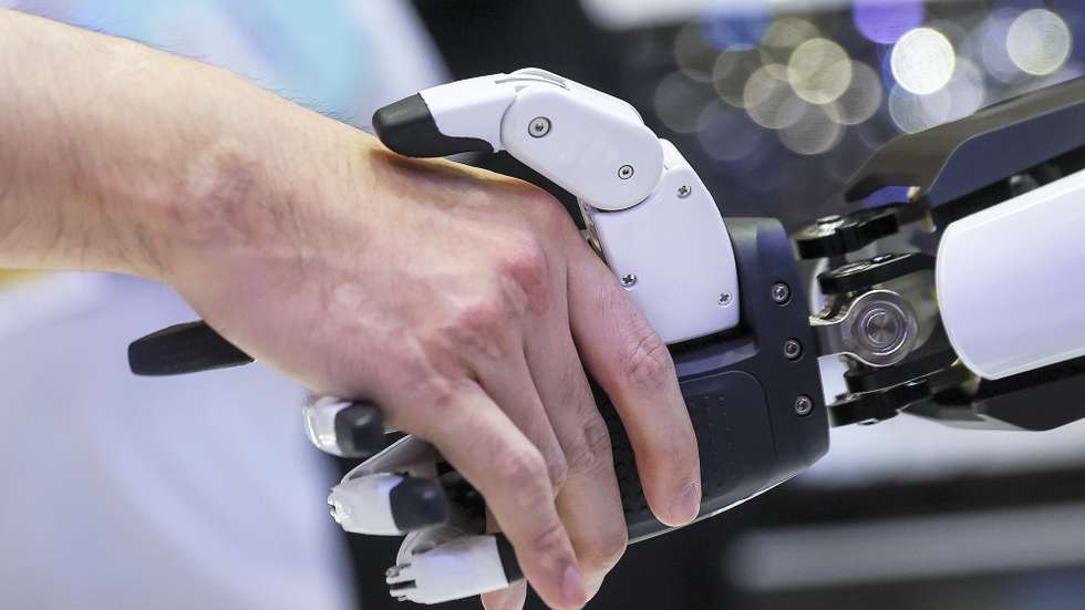epa12091103 People shake hands with 'Mornine,' a Chery Automobile humanoid robot sales assistant, during the Malaysia Autoshow 2025 in Kuala Lumpur, Malaysia, 10 May 2025 (issued 11 May 2025). The Chery AiMOGA robot, nicknamed 'Mornine,' is a 1.66-meter-tall humanoid sales assistant made by Chery. Originally a virtual character for young people, it is now a physical robot with advanced sensors, flexible limbs, and a silicone face with realistic facial expressions. These robots use open-source AI models to interact with people and will be used in Chery showrooms for customer service in the future.  EPA/FAZRY ISMAIL