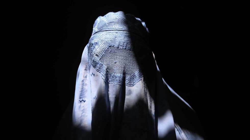 epa05464184 An Afghan woman wearing a traditional burkha walks along a street in Herat, Afghanistan, 08 August 2016. Although Afghanistan's economy has reportedly improved, the country still relies on foreign aid for more than 90 per cent of national income. Ongoing unrest which has increased with the partial withdrawal of foreign troops in January 2015 is regarded the main cause of damage to the potential economic growth.  EPA/JALIL REZAYEE