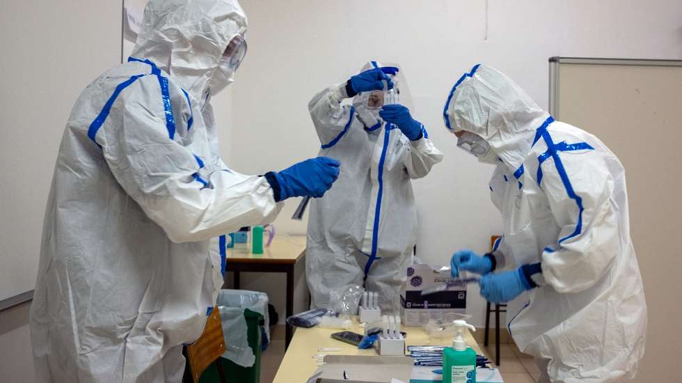 epa08949551 Health professionals during the covid-19 testing in the parish of Ponta Garca, Ponta Delgada, island of Sao Miguel, Azores, Portugal, 19 January 2021. The population is being tested with the COVID-19 rapid tests.  EPA/EDUARDO COSTA