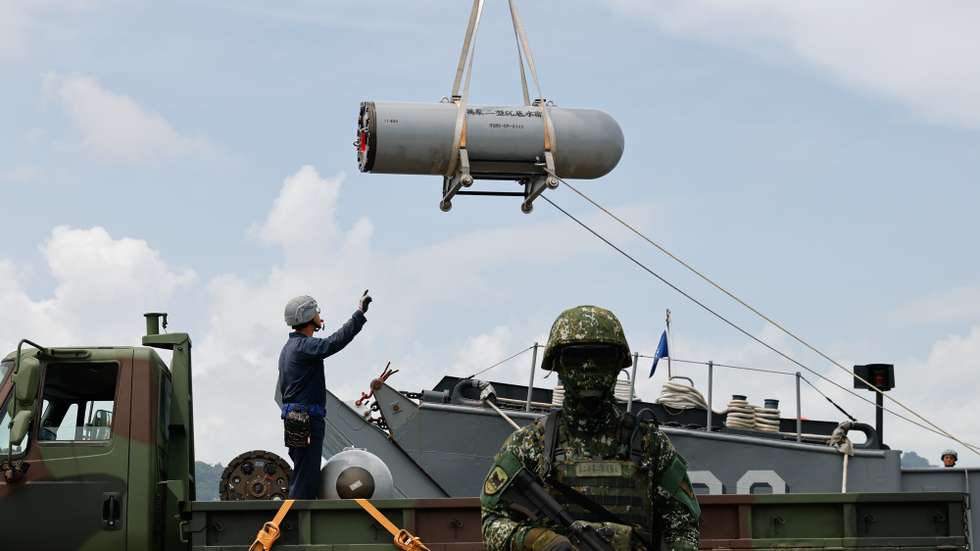 epa12236852 Taiwan navy sailors load sea mines during a drill inside a naval base as part of the annual Han Kuang military exercises, in Kaohsiung city, Taiwan, 14 July 2025. The Taiwanese Armed Forces began the annual Han Kuang exercises, large-scale military drills aimed at testing the troops' defensive capabilities in the event of a potential invasion by China. Han Kuang military exercises are scheduled between 09 to 18 July.  EPA/RITCHIE B. TONGO
