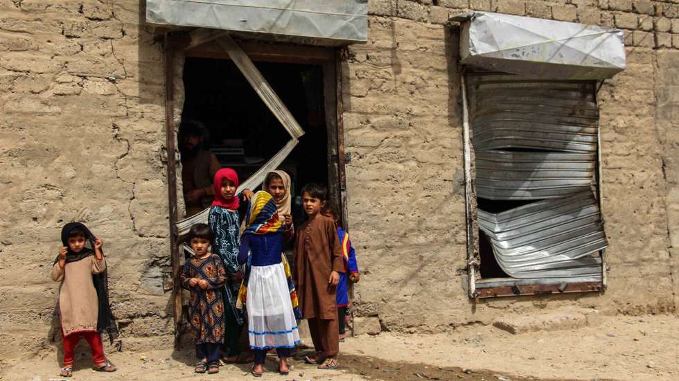 epa09325537 Children stand beside a shop that was damaged after a car bomb exploded nearby in Kandahar, Afghanistan, 06 July 2021. A car bomb exploded near a police center killing at least two police and injuring 24 others in Kandahar. The Taliban on 05 July said they planned to capture no Afghan provincial capital by military force even as its fighters continue making rapid territorial gains amid an ongoing withdrawal of foreign troops from the war-ravaged country. Violence in the country has spiked as representatives of the Afghan government and the Taliban try to resume the stalled intra-Afghan talks in Doha.  EPA/M SADIQ