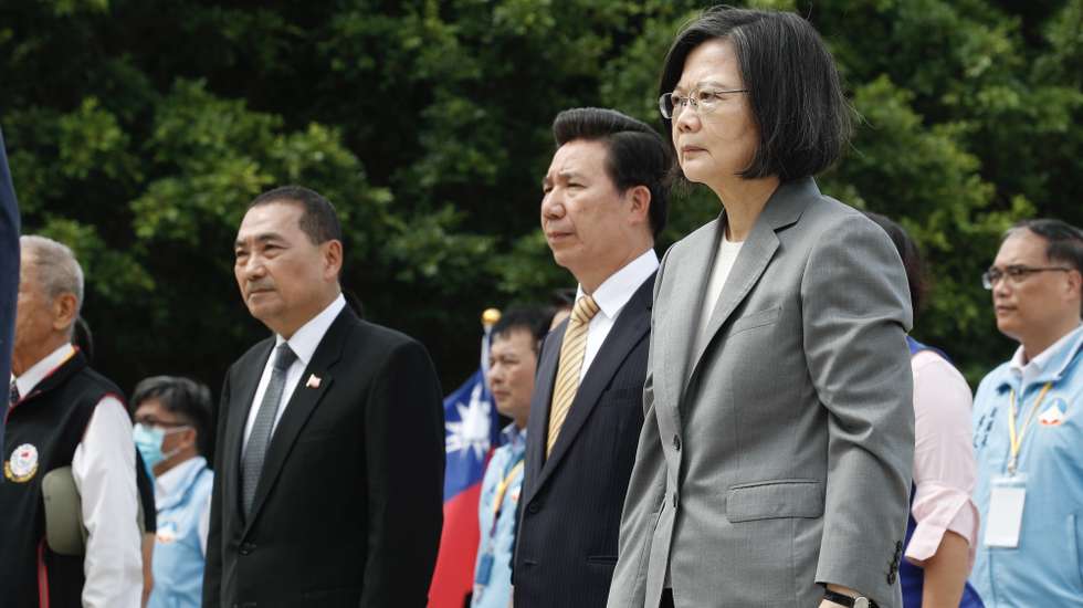 epa10814756 Taiwan President Tsai Ing-wen (R) and Kuomintang Party Presidential candidate Hou Yu-ih (L) react as they attend the wreath laying ceremony for the 65th Anniversary of the artillery battle between Taiwan and China, in Kinmen, Taiwan, 23 August 2023. Taiwan President Tsai Ing-wen visited Kinmen Islands near China to preside over a ceremony observing the 65th Anniversary of the Victory of the August 23rd artillery battle between Taiwan and China.  EPA/RITCHIE B. TONGO