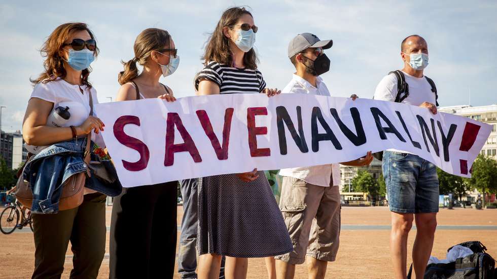 epa09274305 Protesters holds a sign during a peaceful rally to speak up against political repressions, human rights violations and antidemocratic rule in Russia, in Geneva, Switzerland, 15 June 2021. Geneva is hosting a meeting between US President Joe Biden and Russian President Vladimir Putin on 16 June. This is the first European trip for Russian President since nearly a year-and-half of isolation due to COVID. This is an opportunity to call for the release of Alexey Navalny, Russian lawyer and political activist. He has been in prison since mid-January. He had been arrested on his return from Germany, where he had spent nearly five months recovering from a poisoning, he accused the Kremlin of.  EPA/MAGALI GIRARDIN