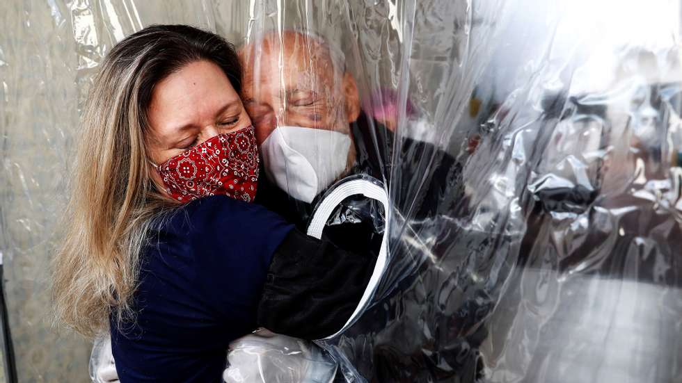 epa08758533 YEARENDER 2020 COVID-19 PANDEMICMaria Paula Moraes today hugs her 82-year-old father through a &#039;hug curtain&#039;, in the city of Sao Paulo, Brazil, 02 July 2020. Hug Curtains became a valid alternative for social distancing measures, during the advance of the coronavirus pandemic in Brazil. Today, despite the advance of the coronavirus pandemic in Brazil, people were able to approach again through a &#039;hug curtain&#039;. More than a hundred days have passed since Maria Paula Moraes last hugged her father. EPA/SEBASTIAO MOREIRA *** Local Caption *** 56191521