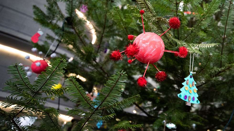 epa08874108 A Christmas tree is decorated with baubles in the shape of the coronavirus at the government office Paul Loebe House in Berlin, Germany, 10 December 2020.  EPA/HAYOUNG JEON