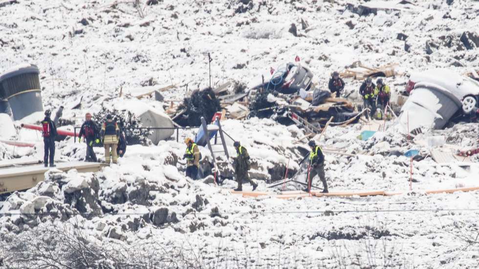 epa08919916 Rescue workers interrupt the search in the ruins, after an alarm was triggered in the area of a major landslide in Ask, some 40 kilometers north of Oslo, Norway, 05 January 2021, after a major landslide destroyed several buildings on 30 December 2020. A number of homes have been taken by the landslide and so far seven people have been found dead, while three are still missing. More than 1,000 people in the area have been evacuated.  EPA/TERJE PEDERSEN  NORWAY OUT