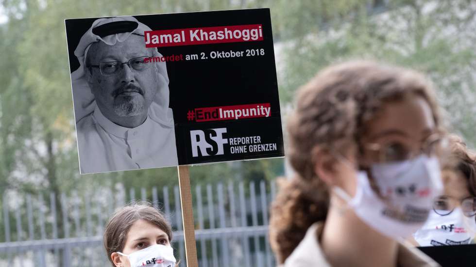 epa08715161 People holding placards reading 'Jamal Khashoggi assasinated 2 October 2018, #EndImpunity' participate in a vigil for the second anniversary of the murdered Saudi journalist Jamal Khashoggi in front of the Saudi-Arabian embassy in Berlin, Germany, 02 October 2020. Washington Post columnist Jamal Khashoggi was killed while visiting the Saudi consulate in Istanbul, Turkey on 02 October 2018 to do a routine paperwork. Three of a total of 11 suspects were given jail sentences of 24 years in total.  EPA/HAYOUNG JEON