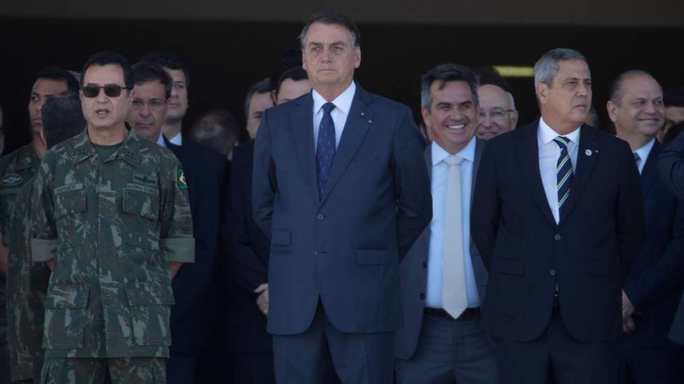 epa09408393 Brazilian President Jair Bolsonaro (C) watches the military convoy pass in front of the Planalto Palace at the main entrance of the Esplanada do Ministerios, in Brasilia, Brazil, 10 August 2021. The president of Brazil, Jair Bolsonaro, received an unusual military parade in Brasilia on 10 August, a display that was seen by the opposition as an attempt by the leader of the Brazilian far-right to intimidate Congress during a key vote for the Government, and that was praised by dozens of supporters who came out to see the event and take pictures of the military equipment.  EPA/Joedson Alves