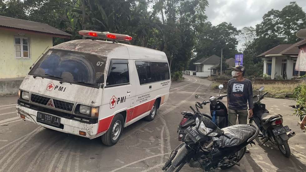 epa11010166 A handout photo made available by the Agam Regional Disaster Management Agency (BPBD) shows an ambulance in transit following the Mount Marapi eruption in Nagari Lasi, Agam, West Sumatra, Indonesia, 03 December 2023 (issued 04 December 2023). At least 11 hikers were found dead after the Marapi volcano erupted on 03 December 2023, according to the Indonesian rescue agency (BASARNAS).  EPA/BPBD AGAM / HANDOUT   HANDOUT EDITORIAL USE ONLY/NO SALES HANDOUT EDITORIAL USE ONLY/NO SALES